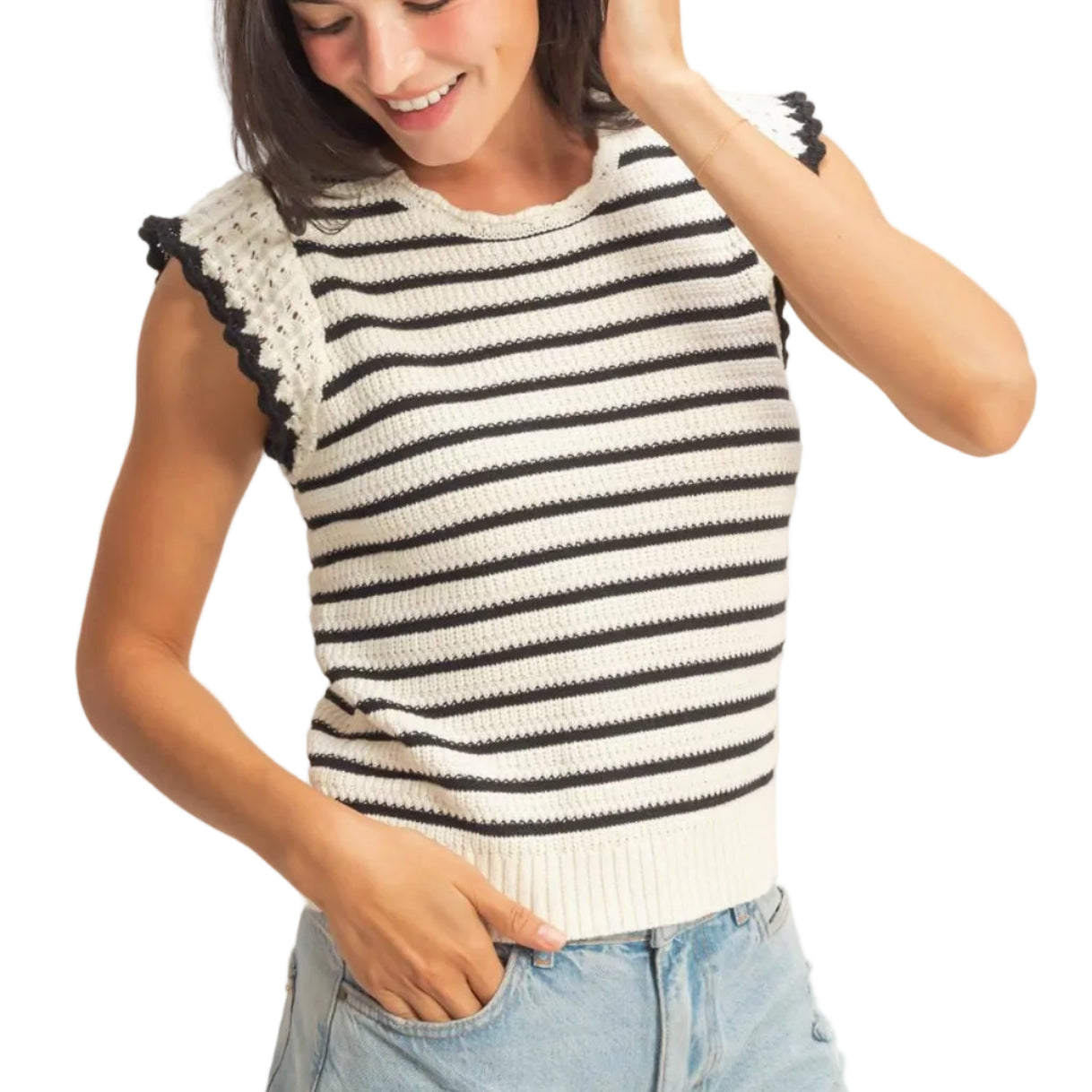 Woman wearing a black and white striped sleeveless top with denim shorts on a plain background