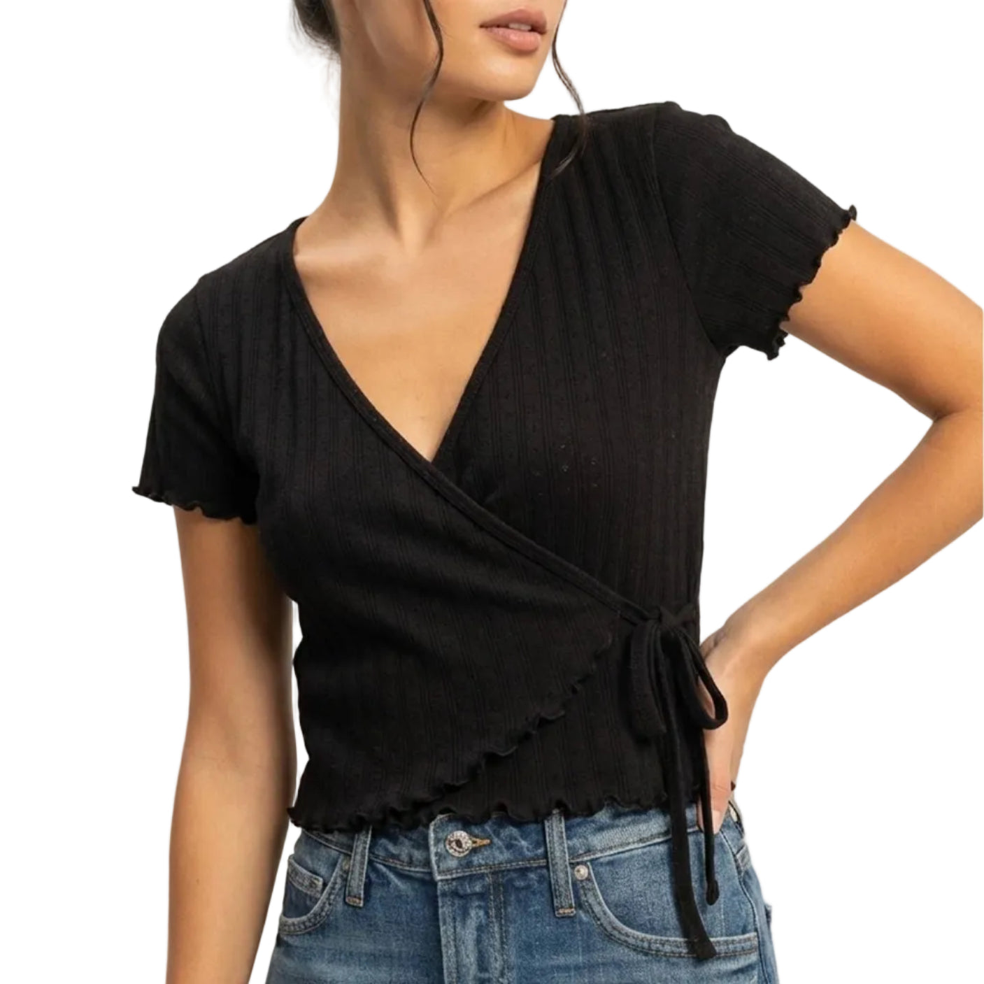 Woman wearing a black top and denim skirt on a plain background