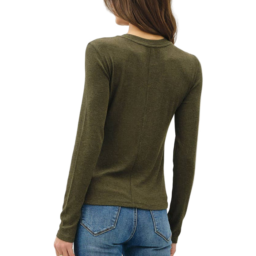 Person wearing a green sweater and blue jeans on a white background