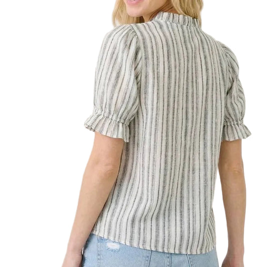 Woman wearing a striped blouse with puff sleeves on a beige background