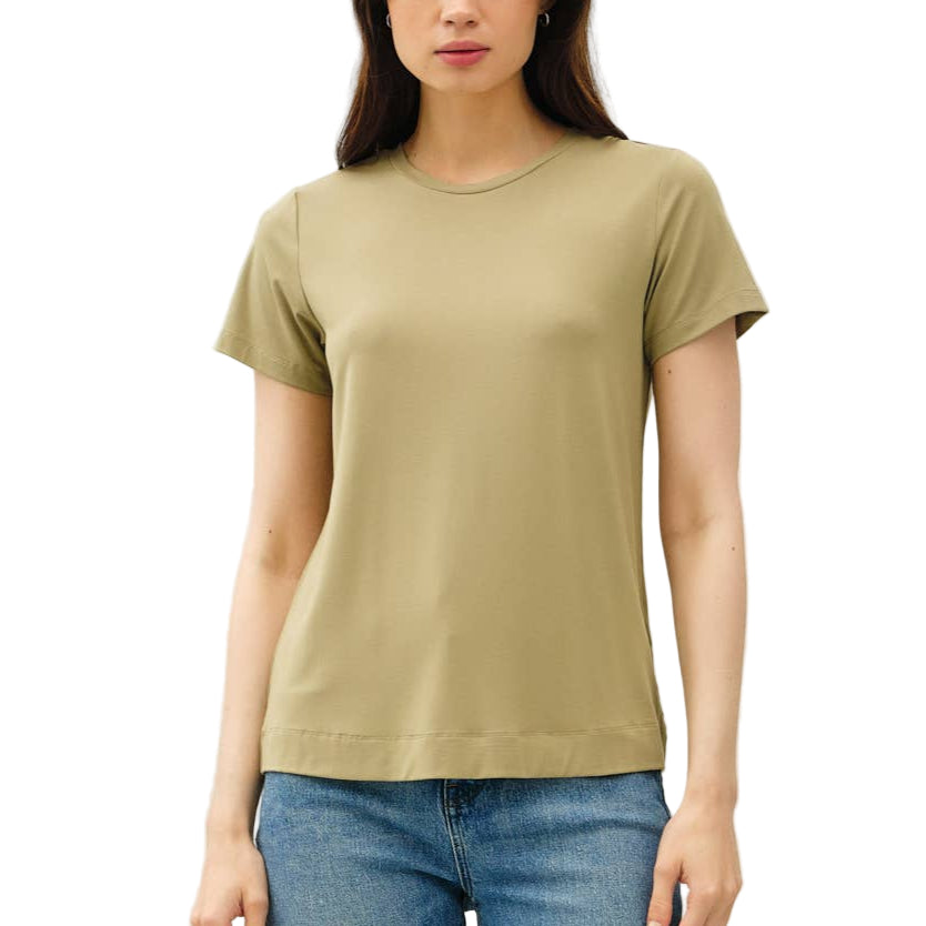 Woman wearing a green t-shirt and blue jeans on a white background