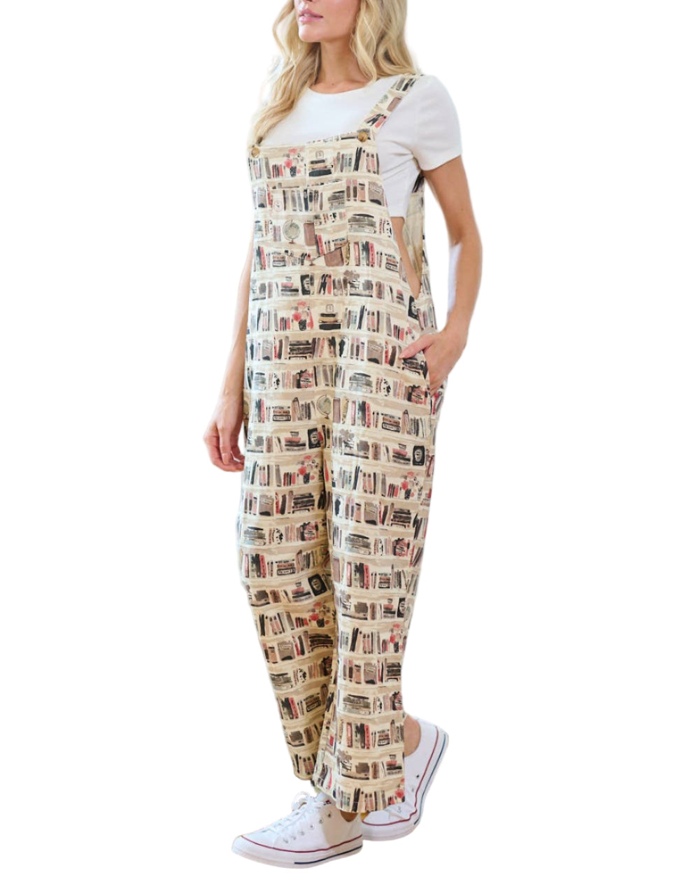 Woman wearing patterned overalls standing in a living room.