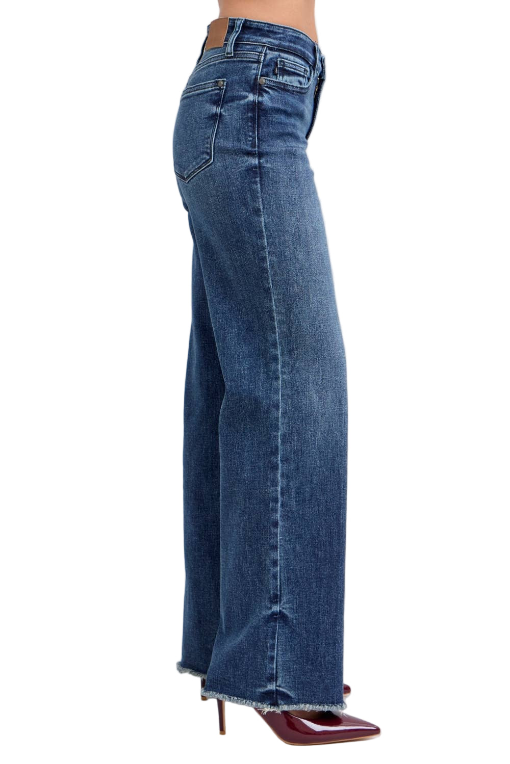 Blue jeans worn by a person on a white background