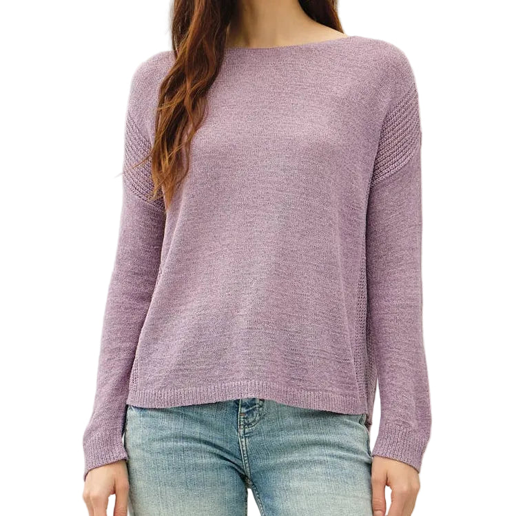 Woman wearing a purple sweater and light blue jeans on a white background