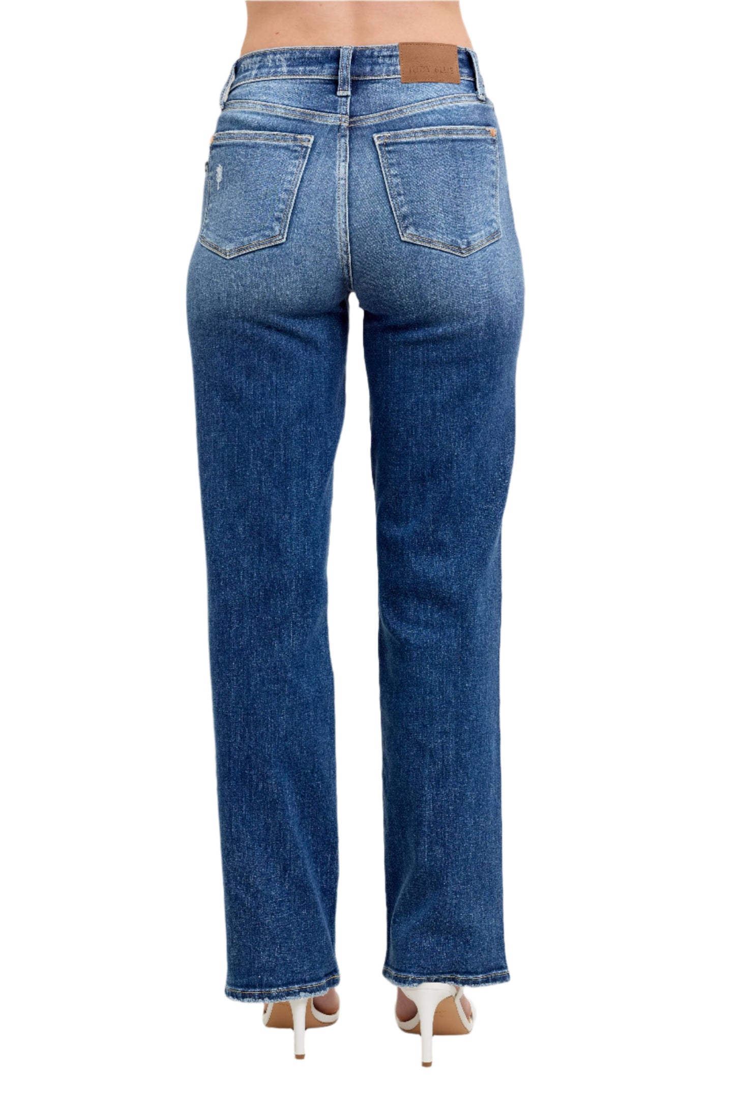 Blue jeans worn by a person on a plain background