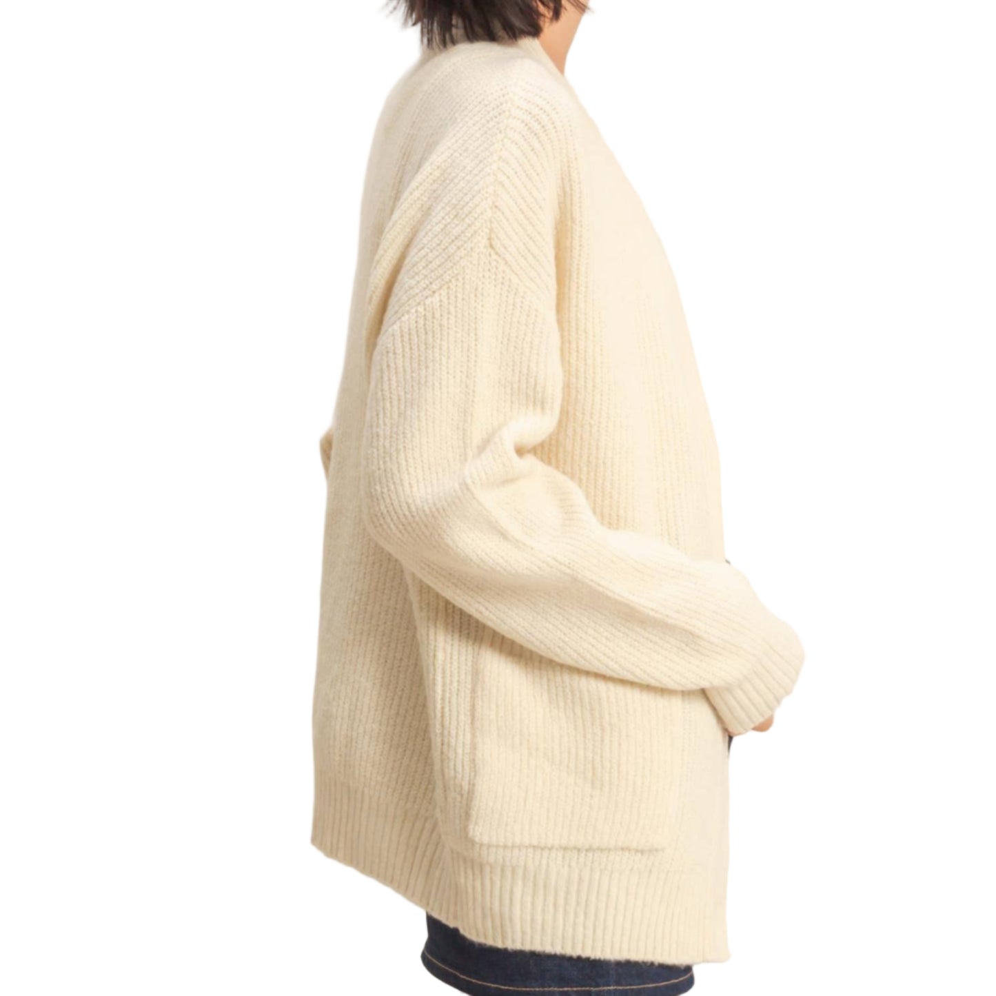 Woman wearing a cream sweater against a plain background