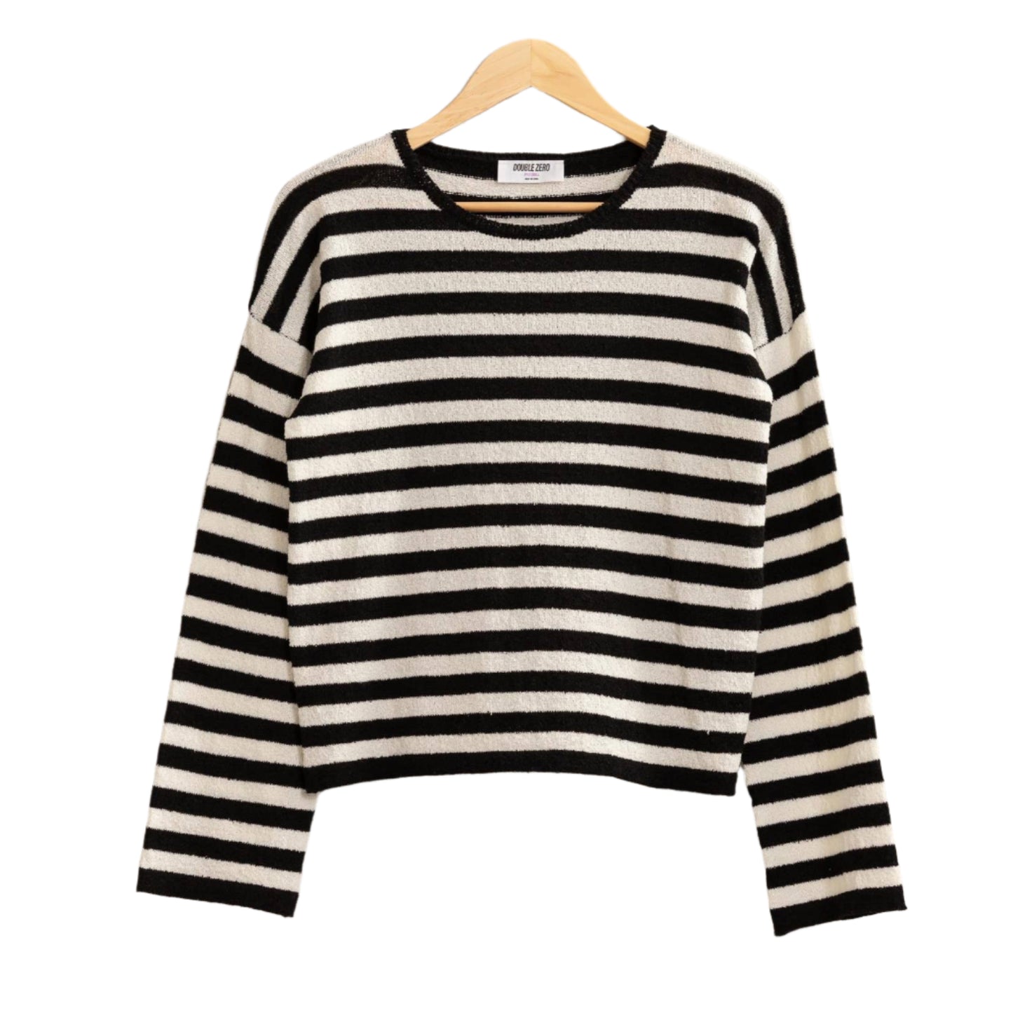 Black and white striped sweater on a hanger against a plain background