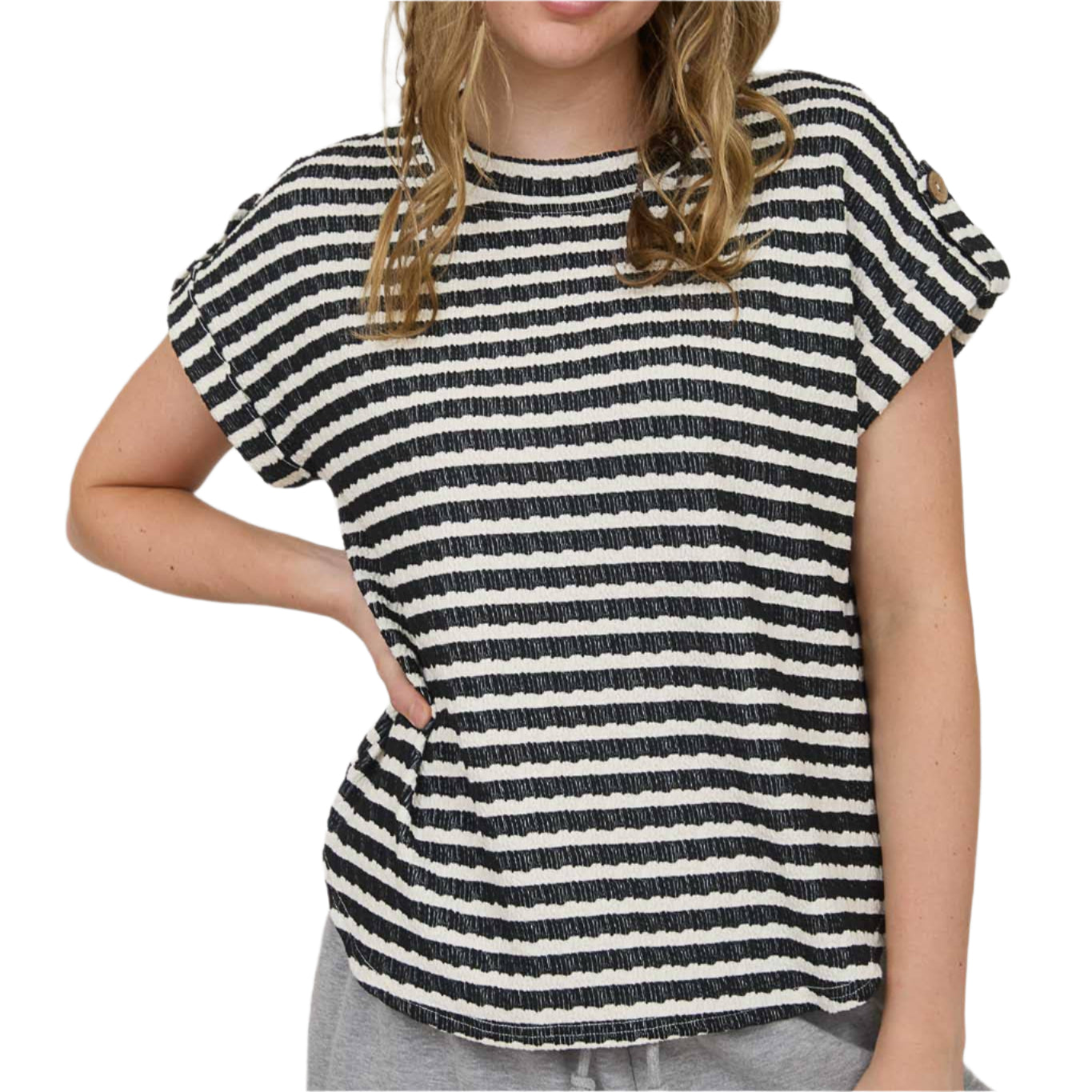Woman wearing a black and white striped shirt against a plain background