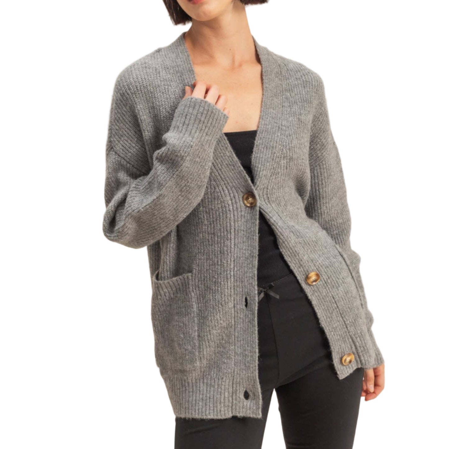 Woman wearing a gray cardigan with gold buttons on a beige background