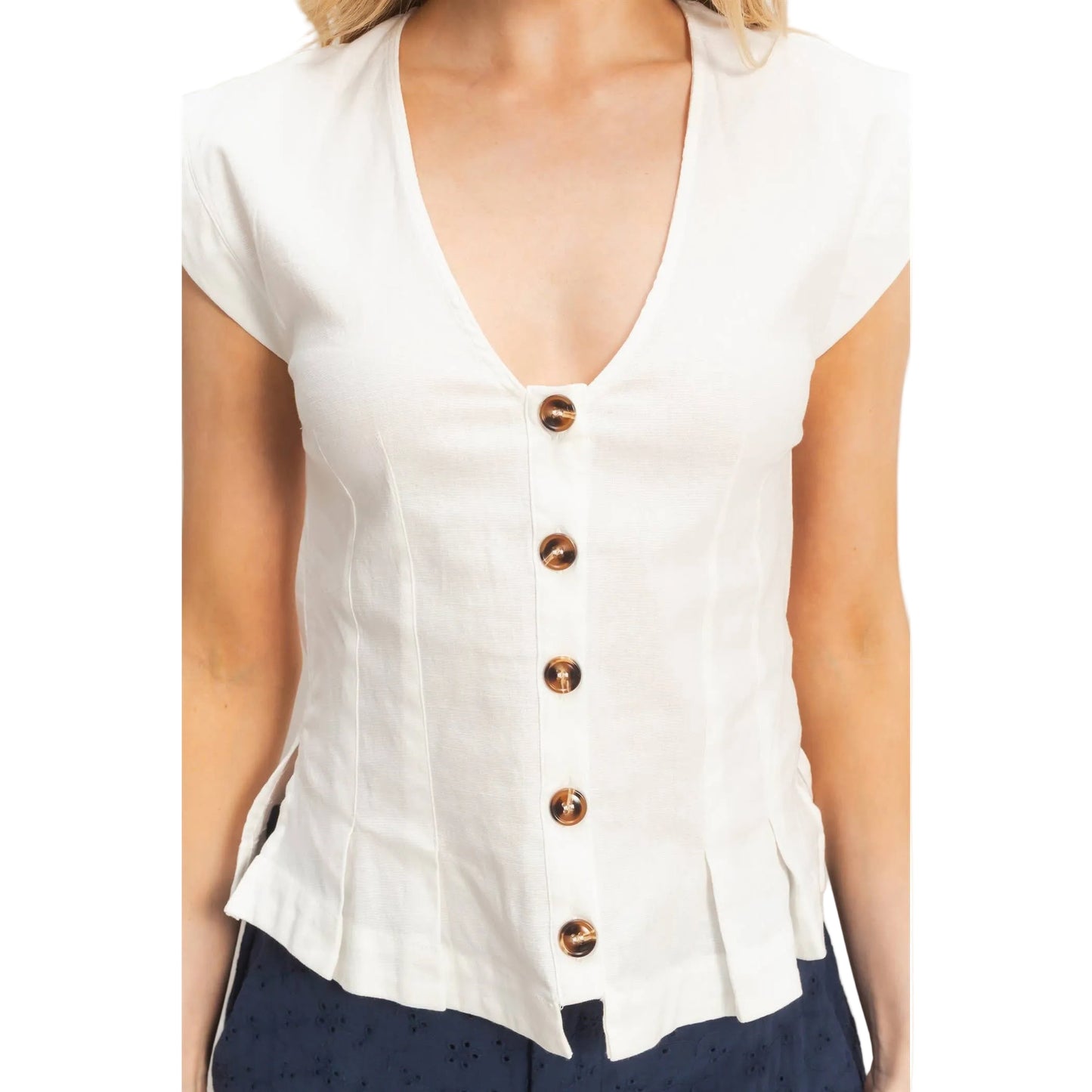 White blouse with copper buttons on a plain background