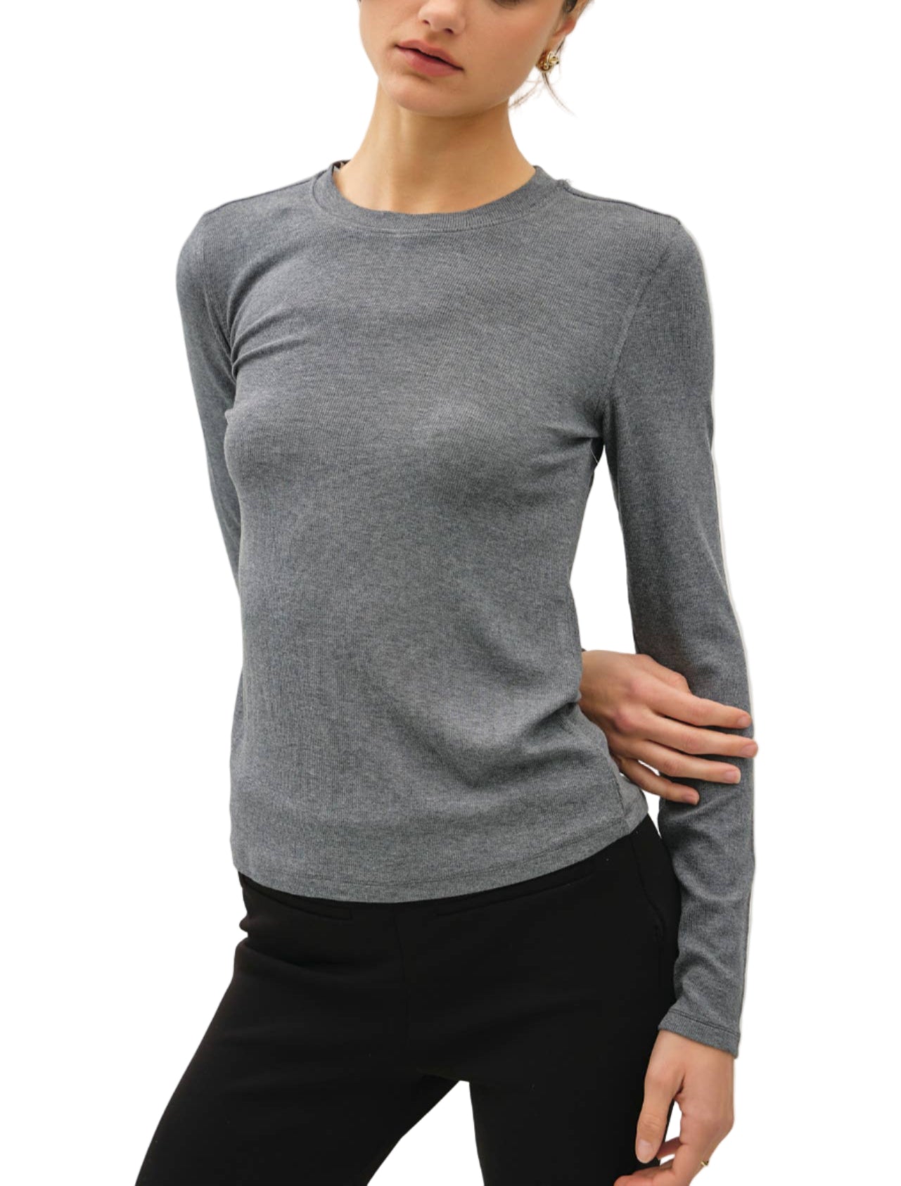 Woman wearing a gray sweater against a plain background