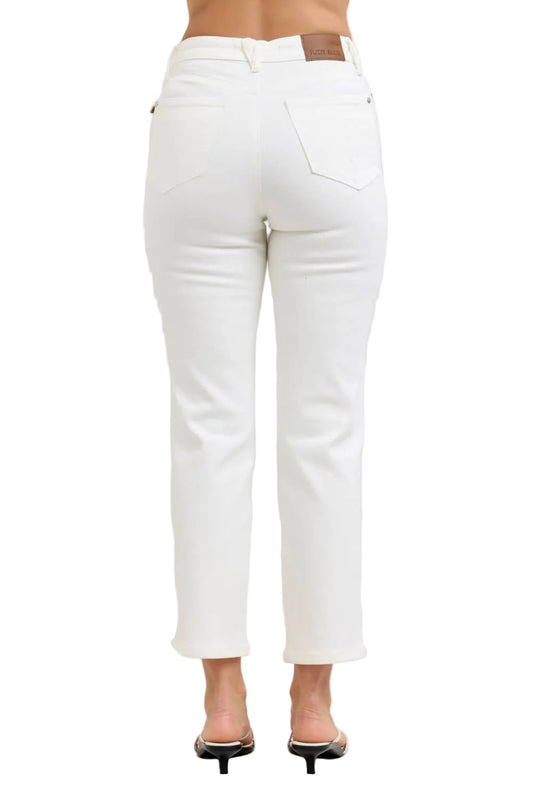 White jeans worn by a person on a plain background