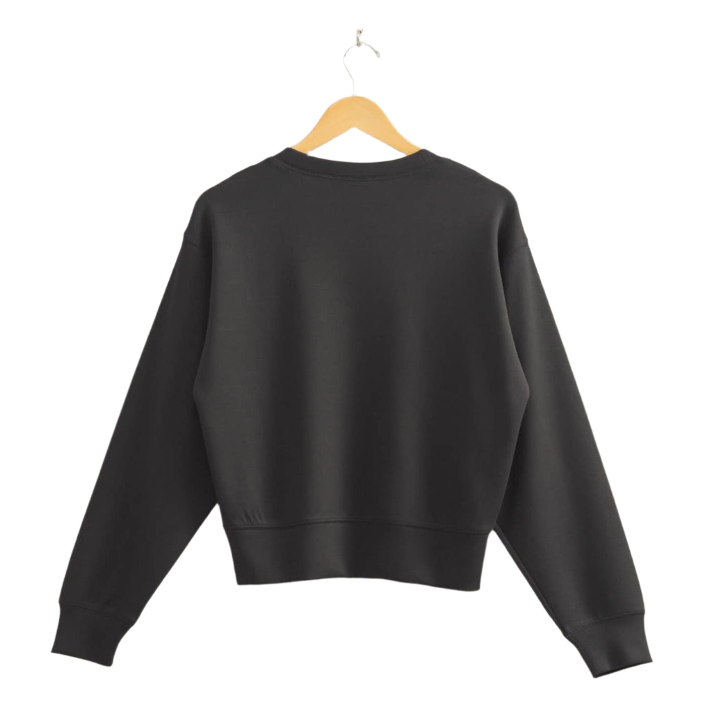 Black sweatshirt on a wooden hanger against a beige wall