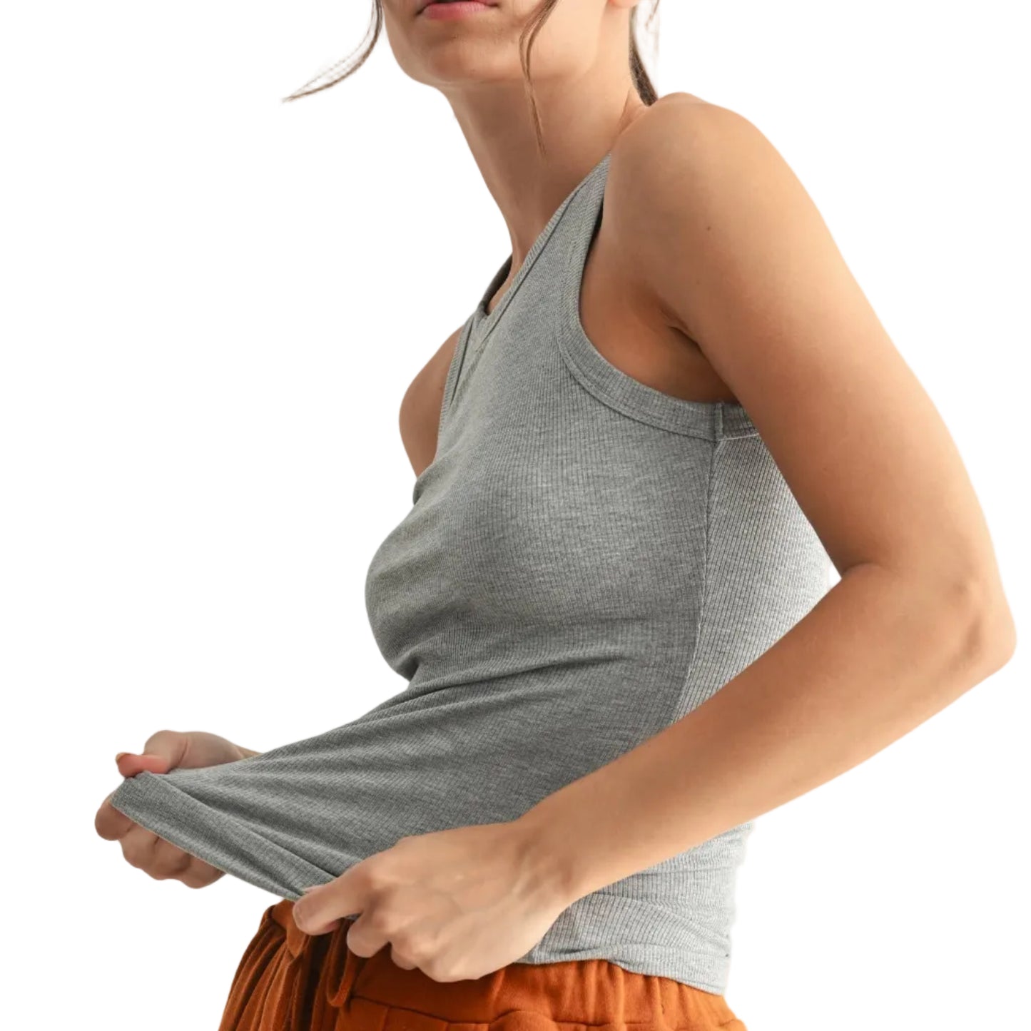 Woman wearing a gray tank top and orange pants on a white background