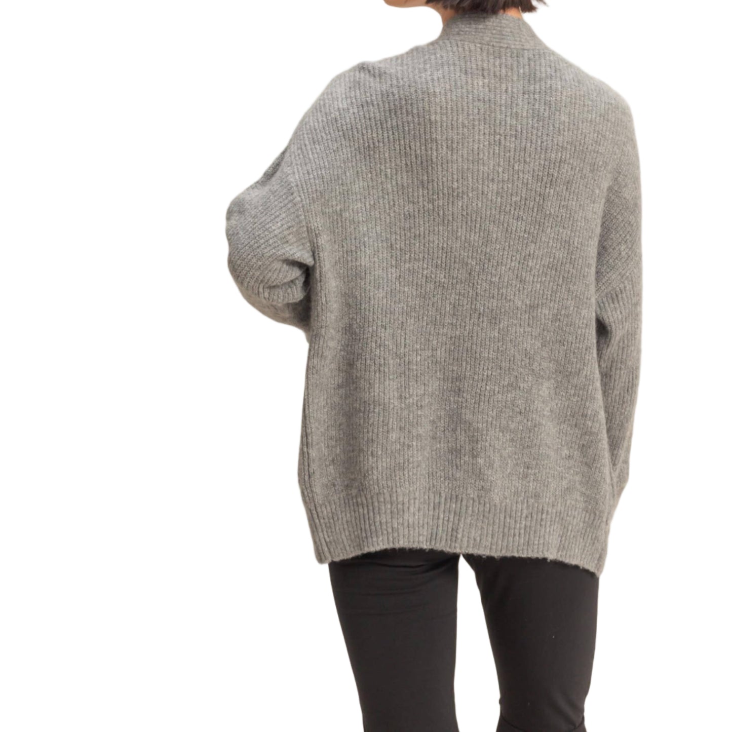 Person wearing a gray sweater on a beige background