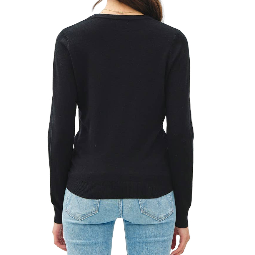 Person wearing a black long-sleeve top and light blue jeans on a white background