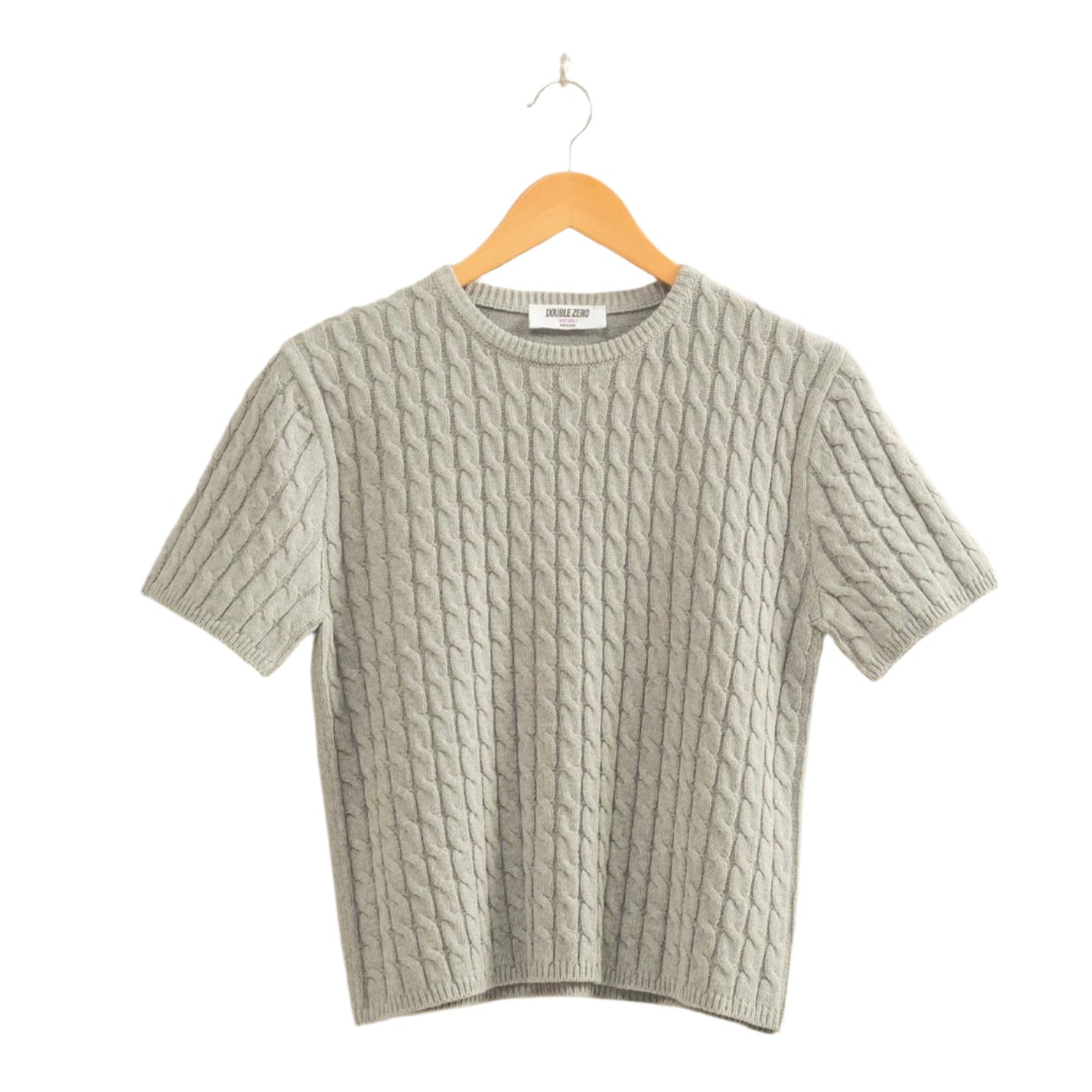 Gray textured sweater on a hanger against a beige background