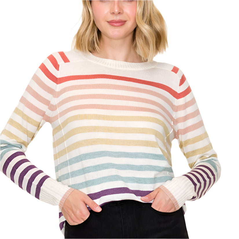 Woman wearing a colorful striped sweater against a plain background