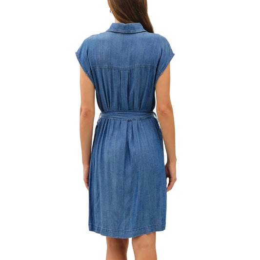 Woman wearing a blue denim dress against a white background