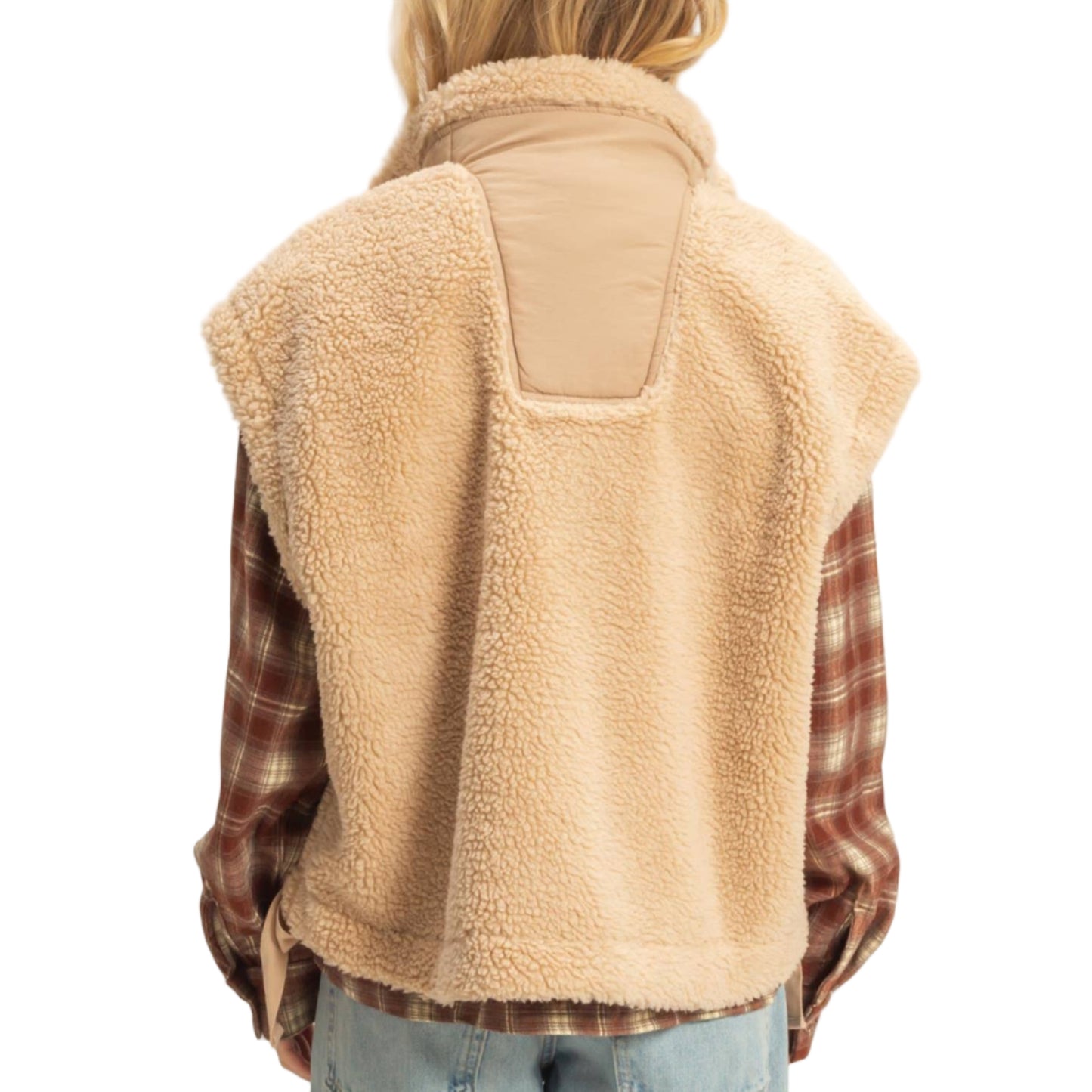 Person wearing a beige fleece vest over a plaid shirt with a neutral background