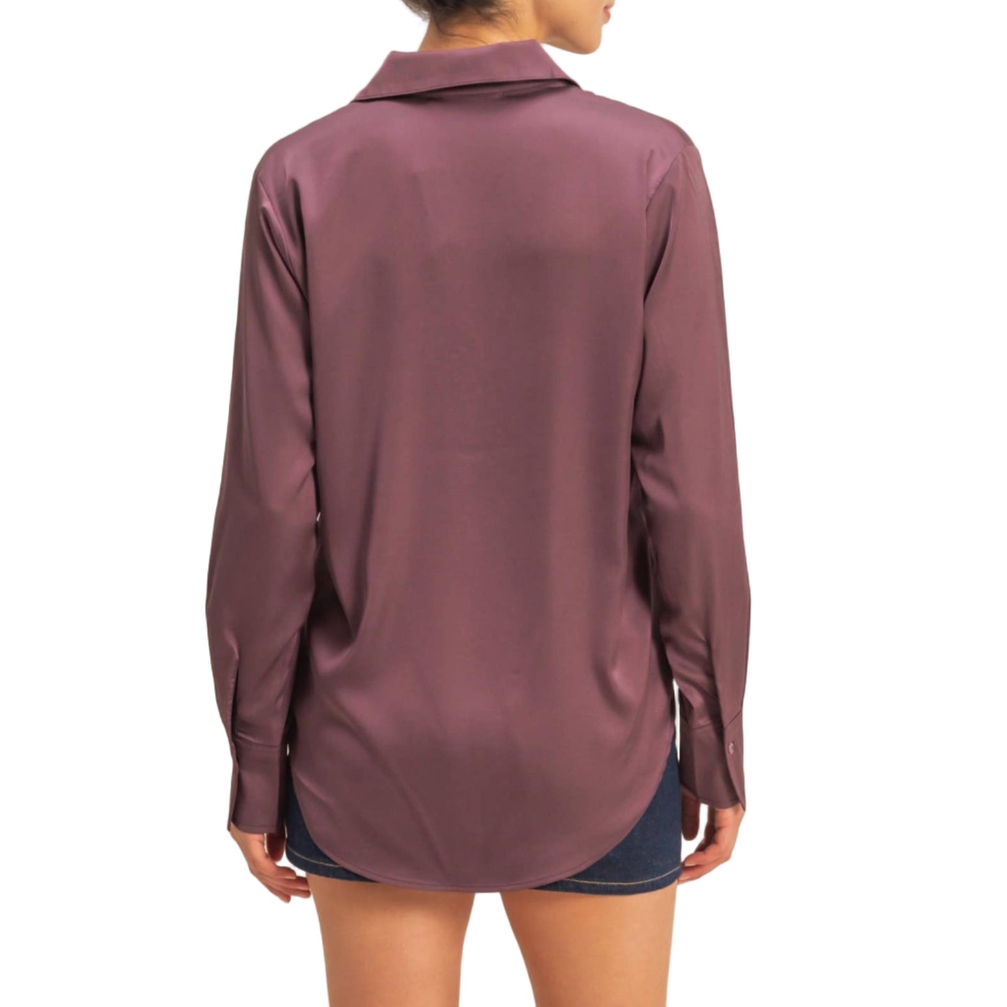 Woman wearing a long-sleeve maroon shirt against a beige background