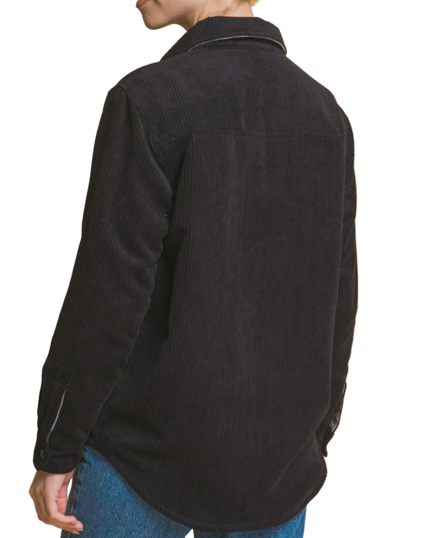Person wearing a black jacket on a beige background