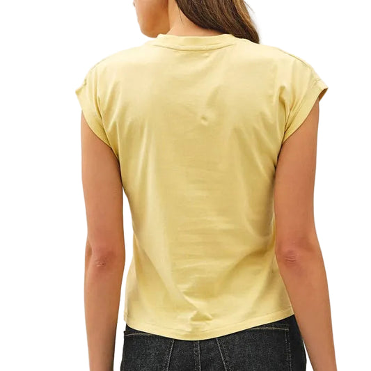 Woman wearing a yellow t-shirt and black jeans against a white background