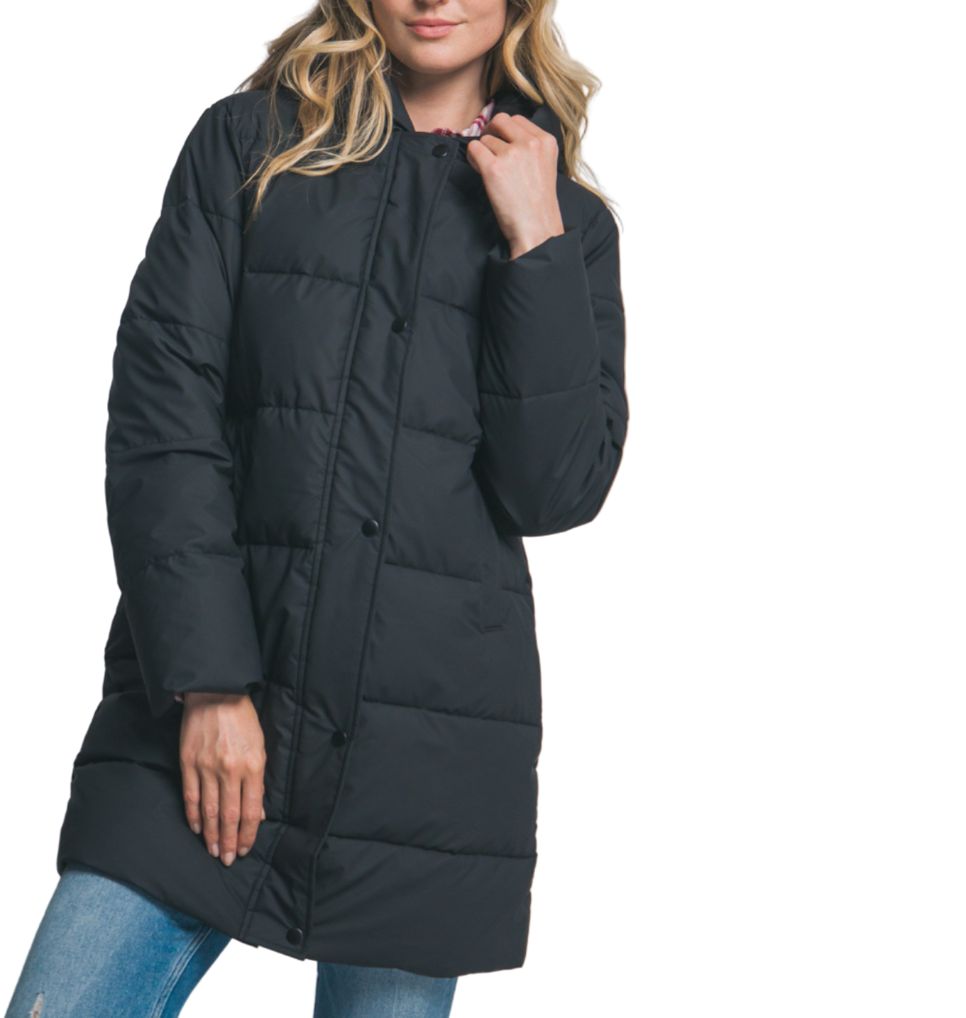 Woman wearing a black puffer coat and blue jeans on a plain background