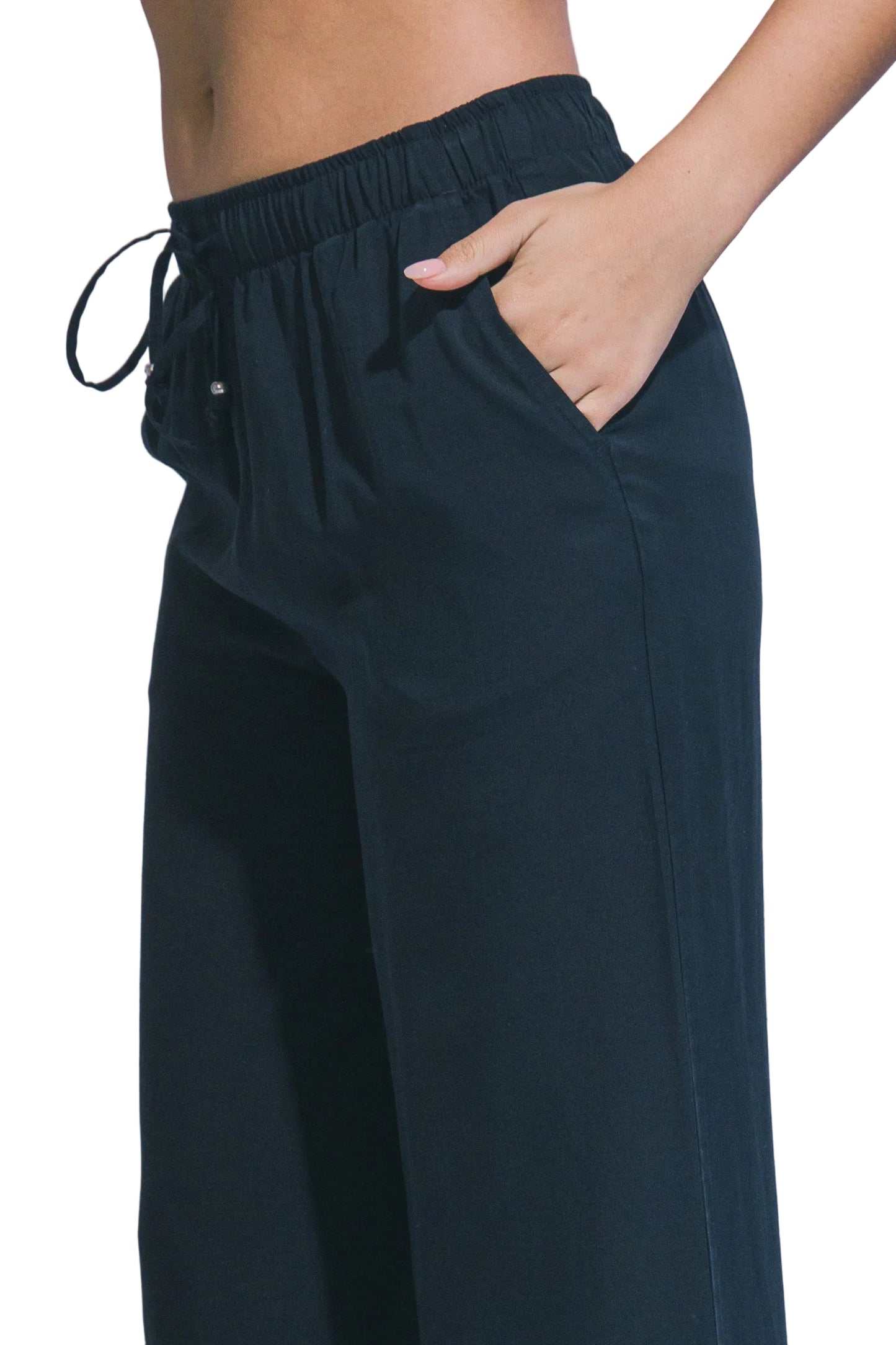 Navy blue pants worn by a person on a light gray background
