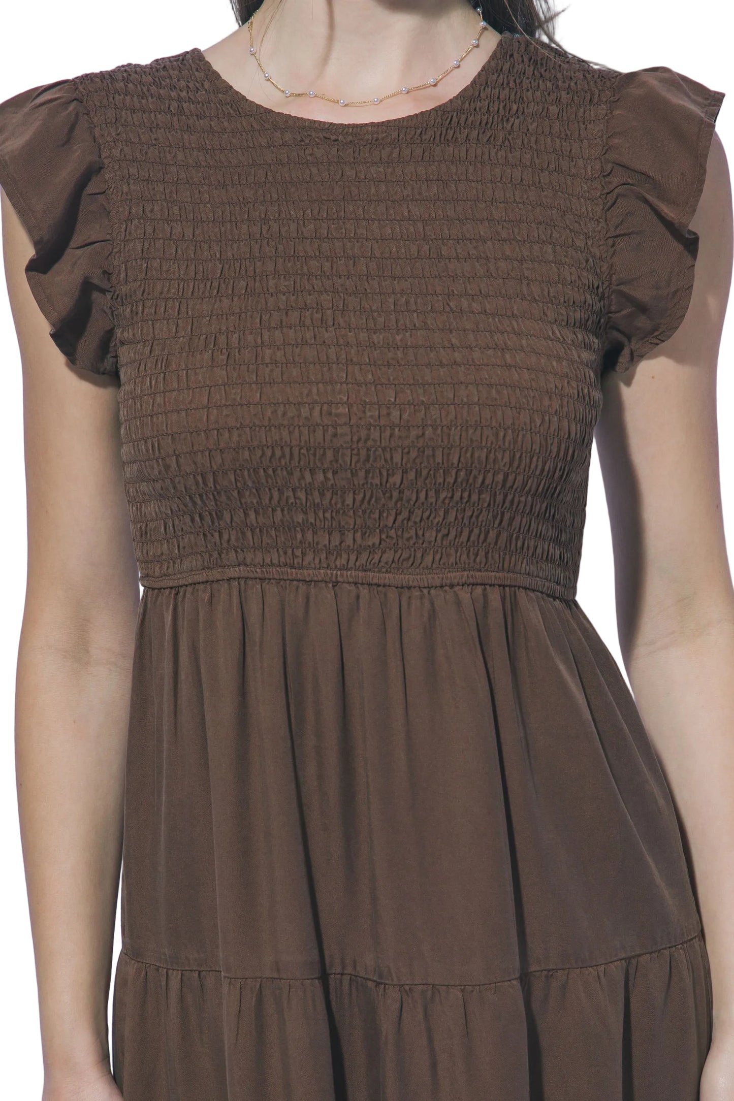 Brown dress with smocked bodice and plain background