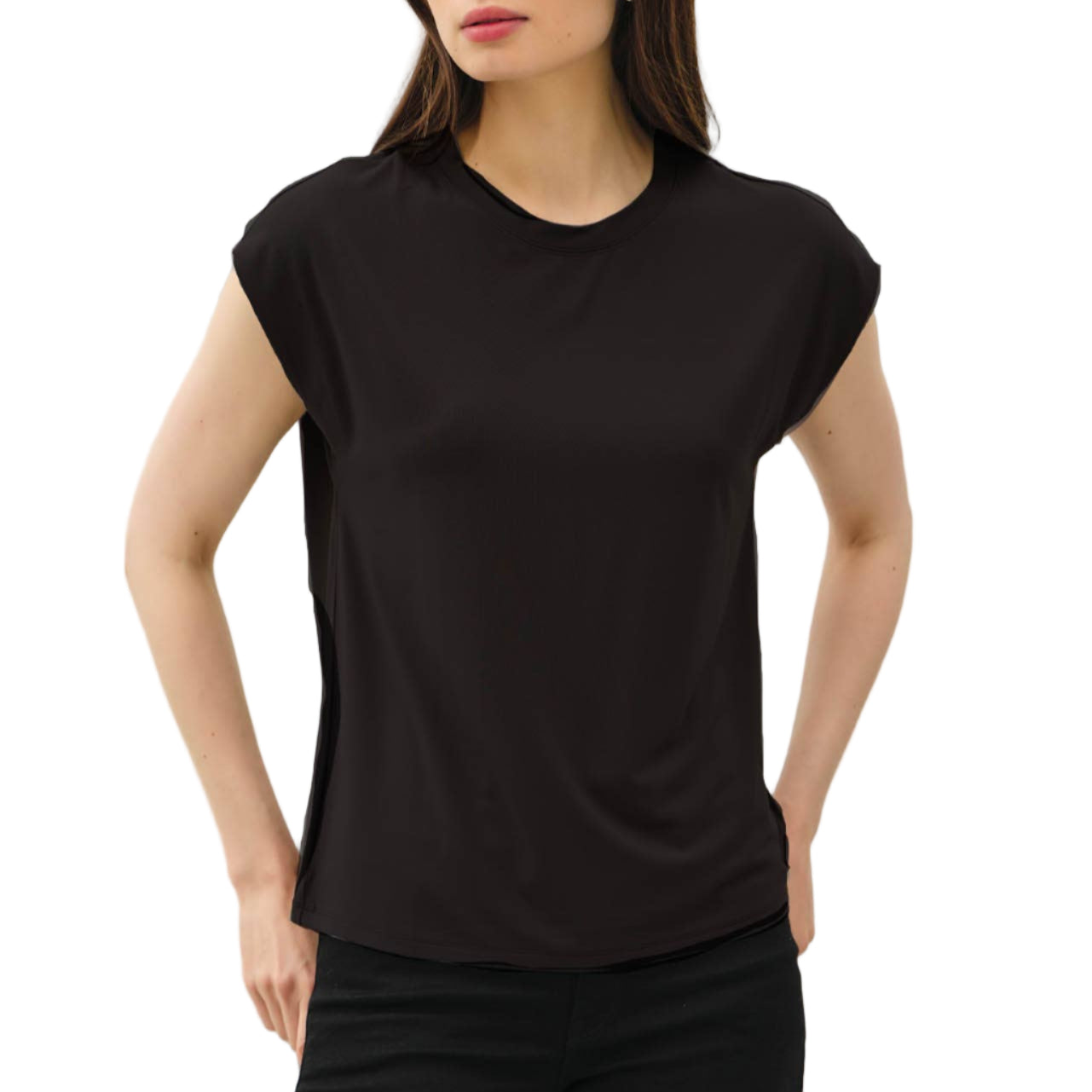 Woman wearing a black sleeveless top and black pants against a light gray background