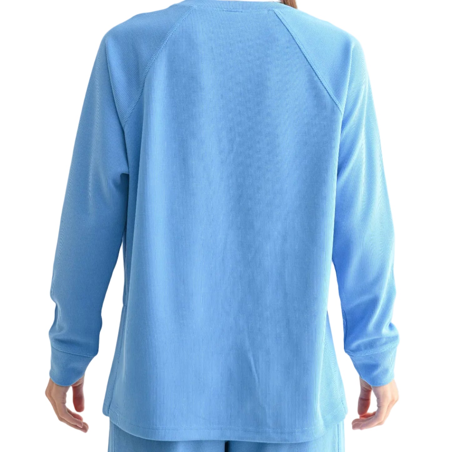 Person wearing a blue long-sleeve top and pants on a white background