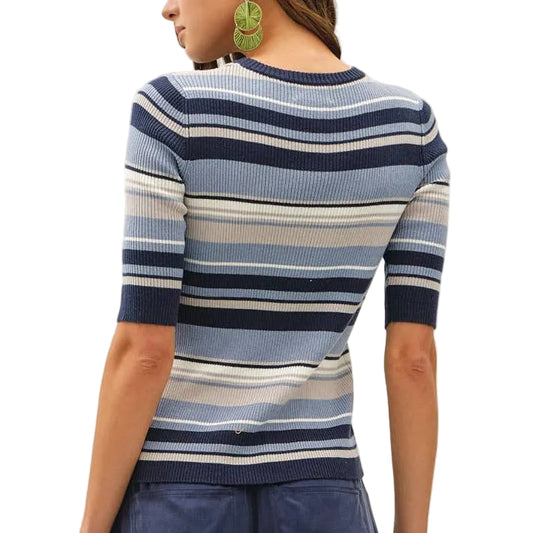 Woman wearing a striped sweater and wide-leg pants on a white background