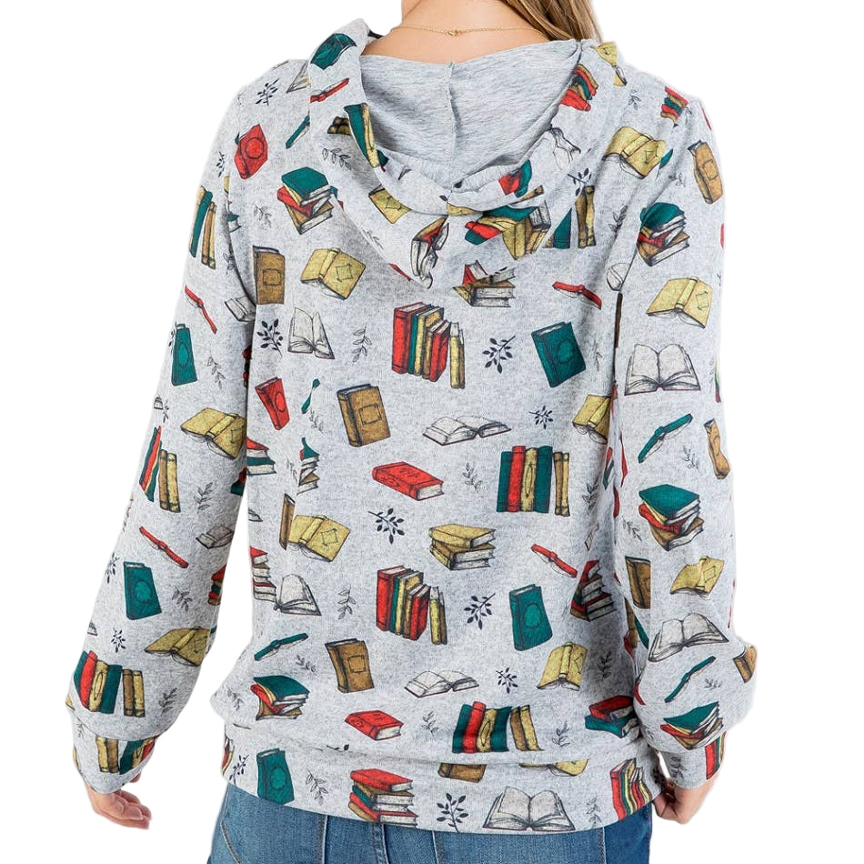Person wearing a hoodie with book design on a white background