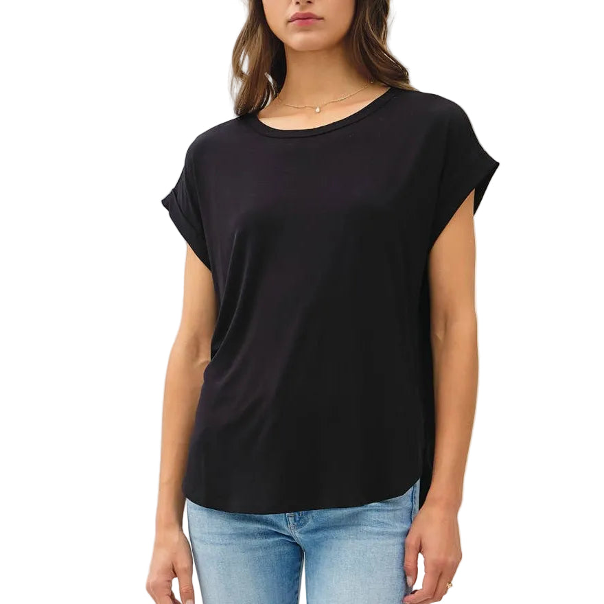 Woman wearing a black t-shirt and light blue jeans on a white background