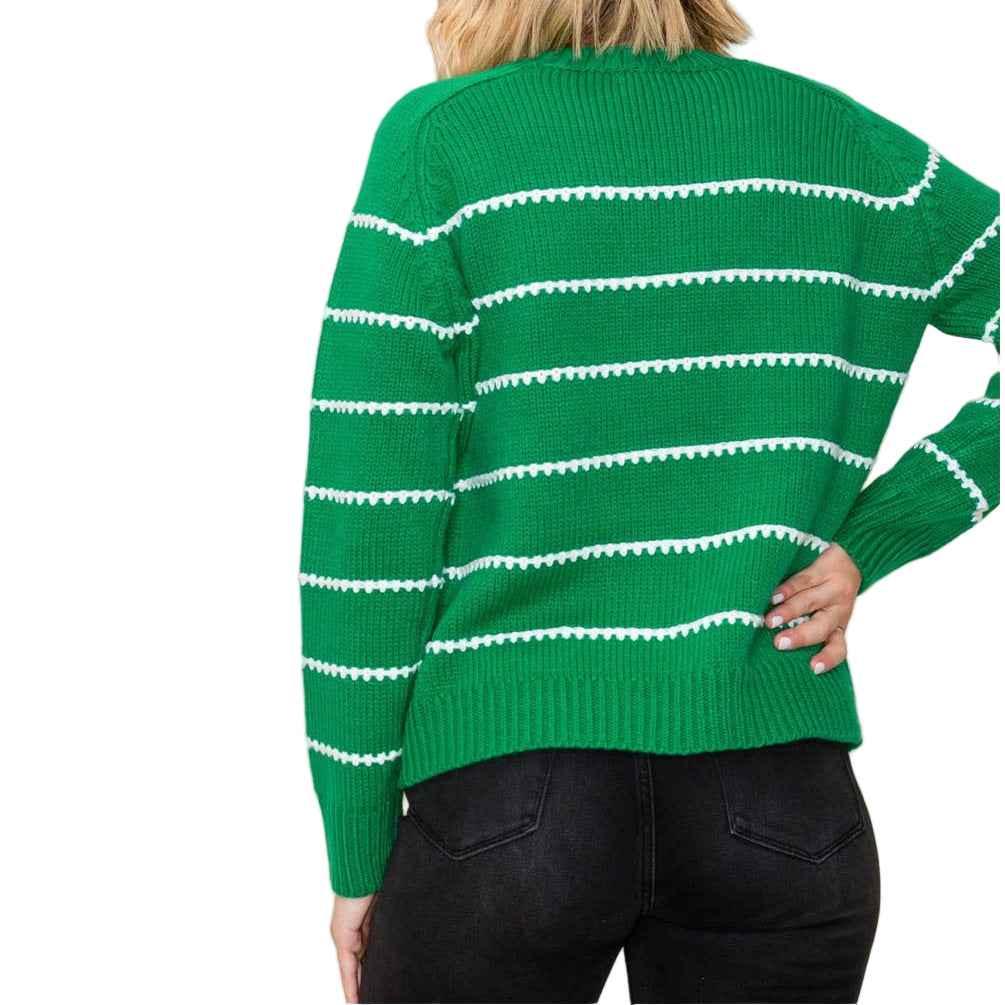Green sweater with white stripes worn by a person on a plain background