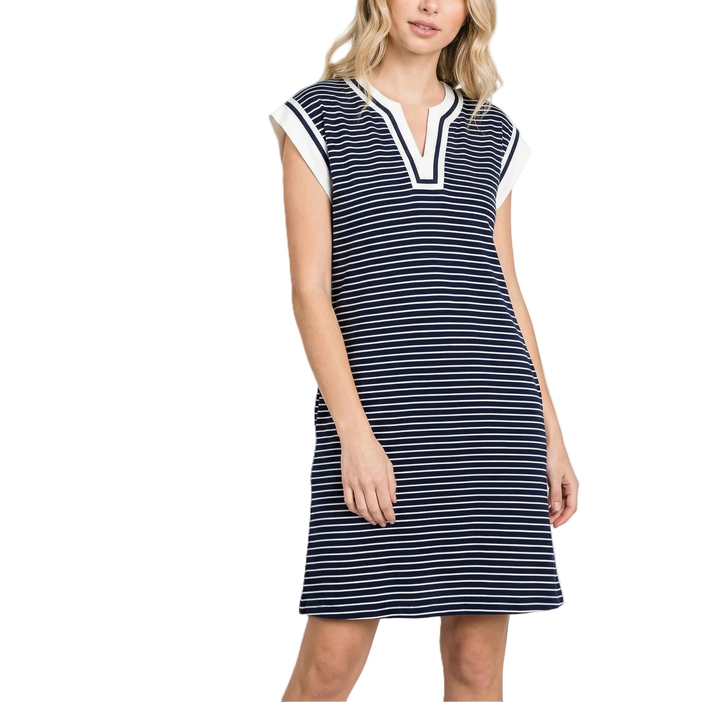 Woman wearing a navy and white striped dress on a light gray background