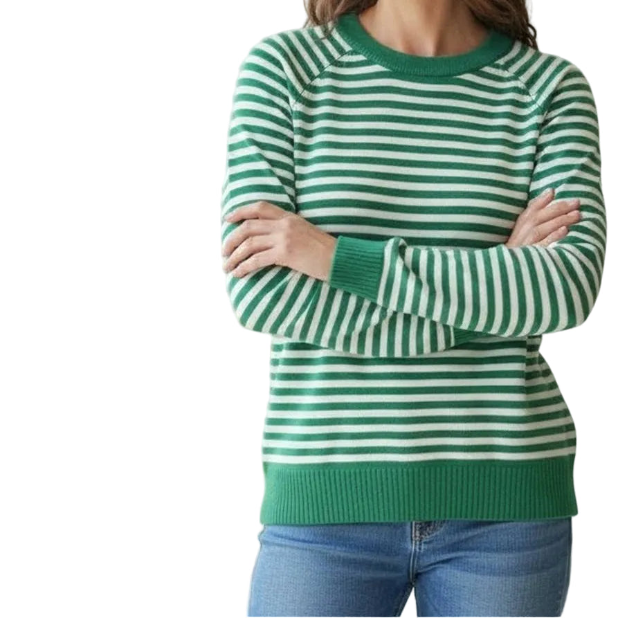 Woman wearing a green and white striped sweater in a casual setting