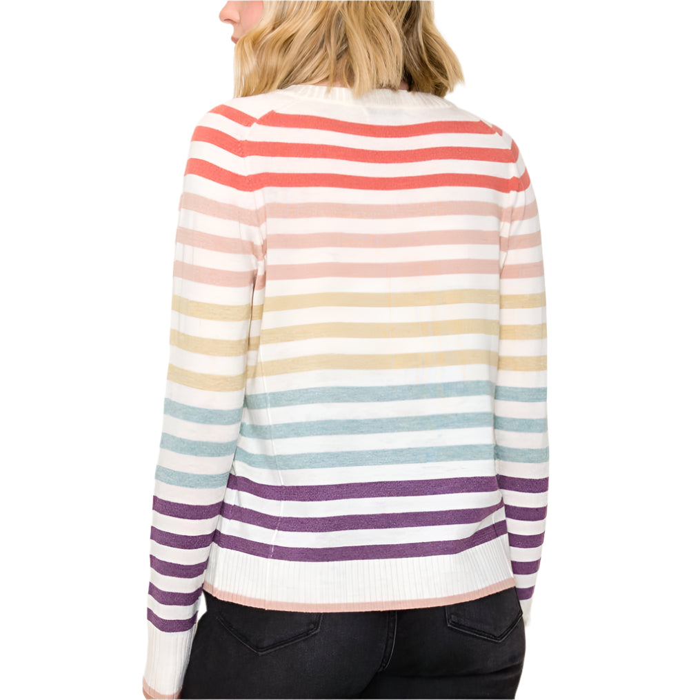 Woman wearing a colorful striped sweater on a plain background