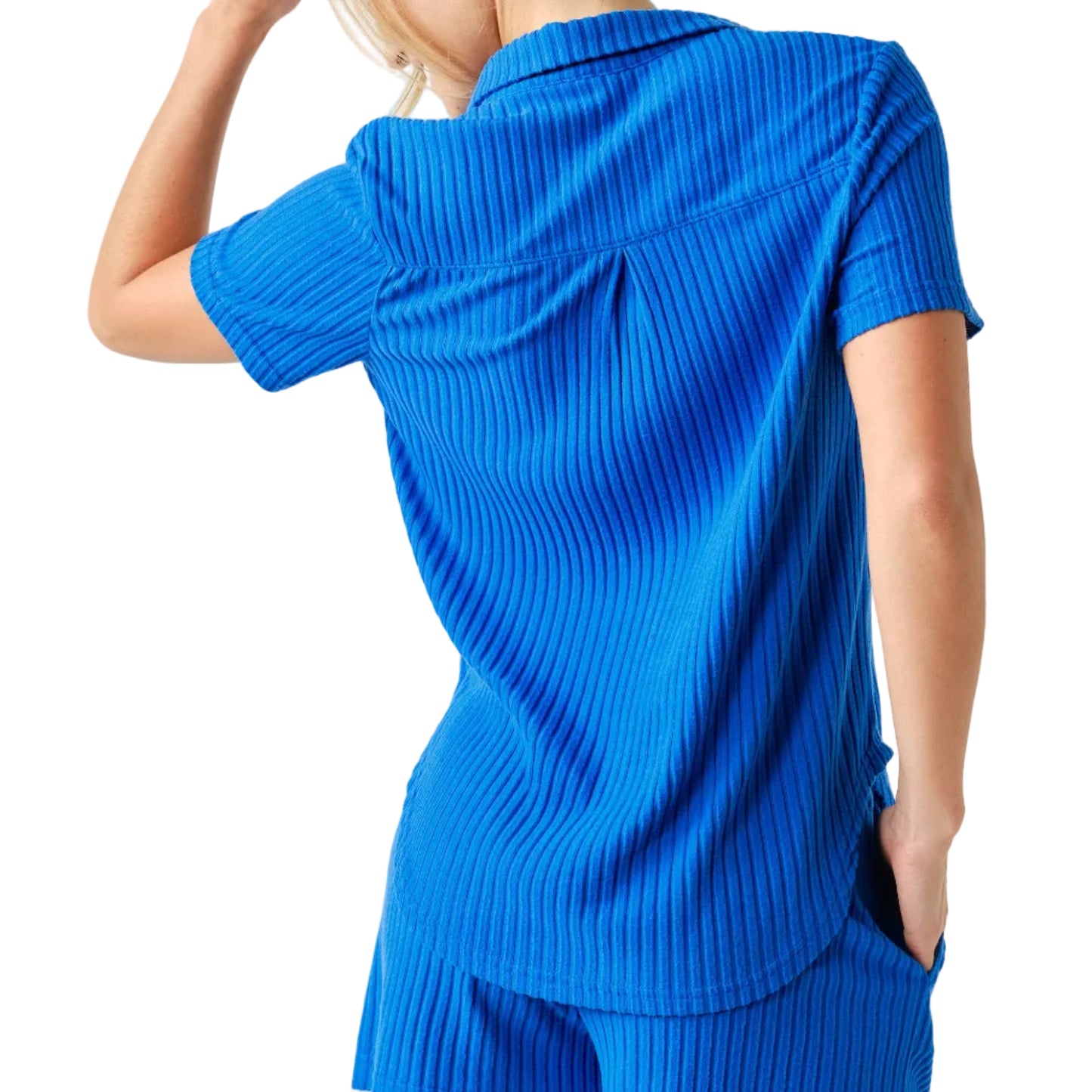 Person wearing a blue ribbed outfit on a white background