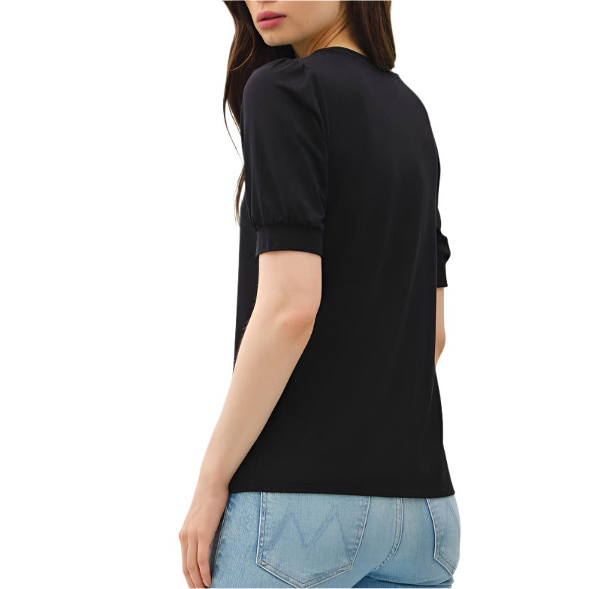 Person wearing a black top and light blue jeans on a white background