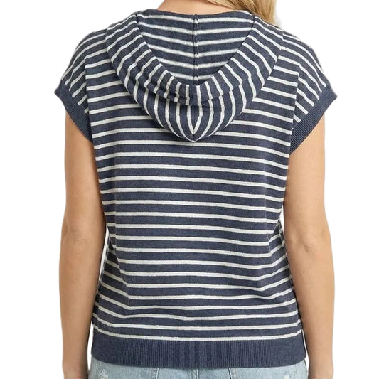 Woman wearing a navy and white striped sleeveless hoodie on a beige background