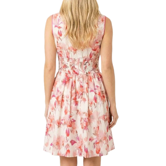 Woman wearing a floral dress on a plain background