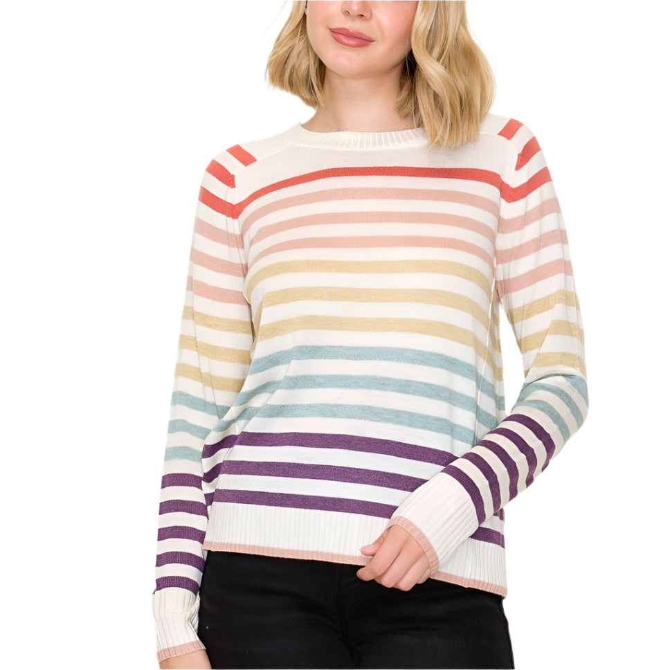 Woman wearing a colorful striped sweater against a plain background