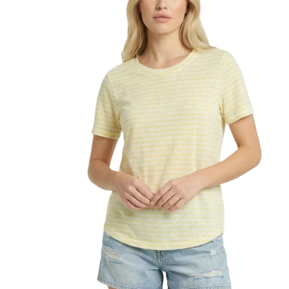 Woman wearing a yellow striped shirt and denim shorts on a white background