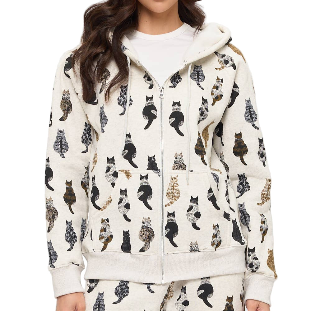 Woman wearing a white hoodie with black cat pattern on a white background