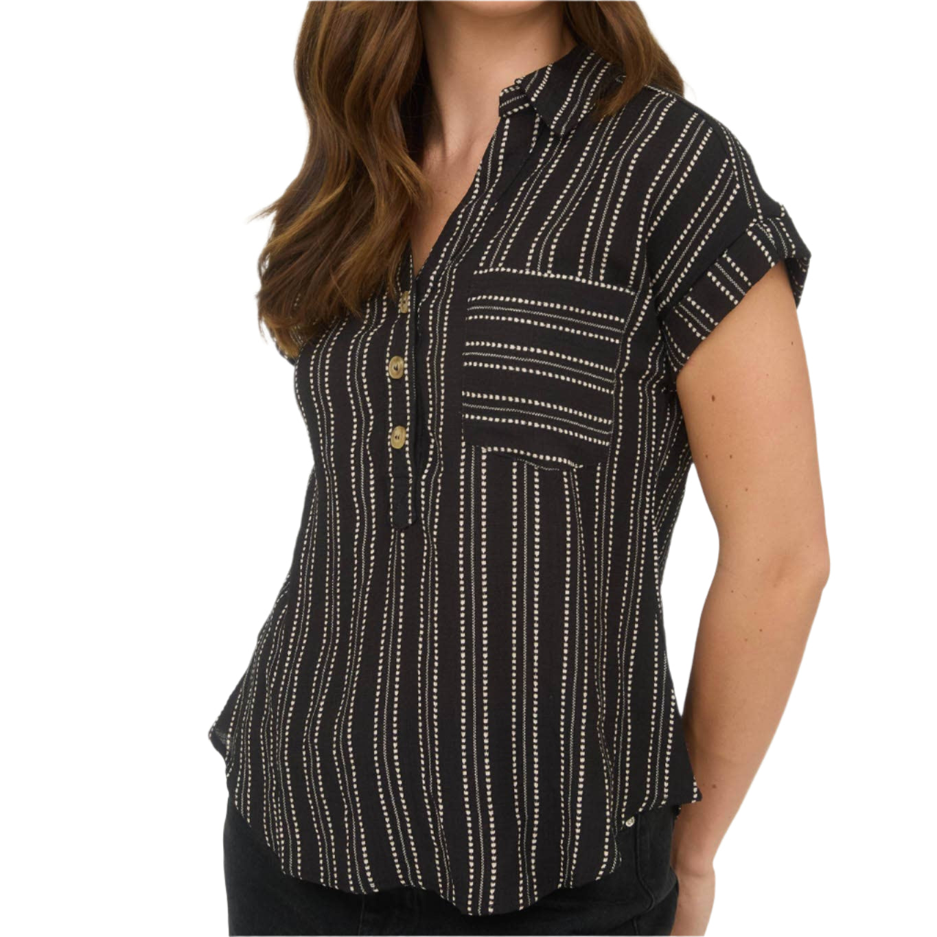 Woman wearing a black patterned shirt against a white background