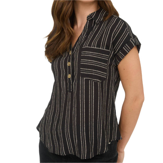 Woman wearing a black patterned shirt against a white background