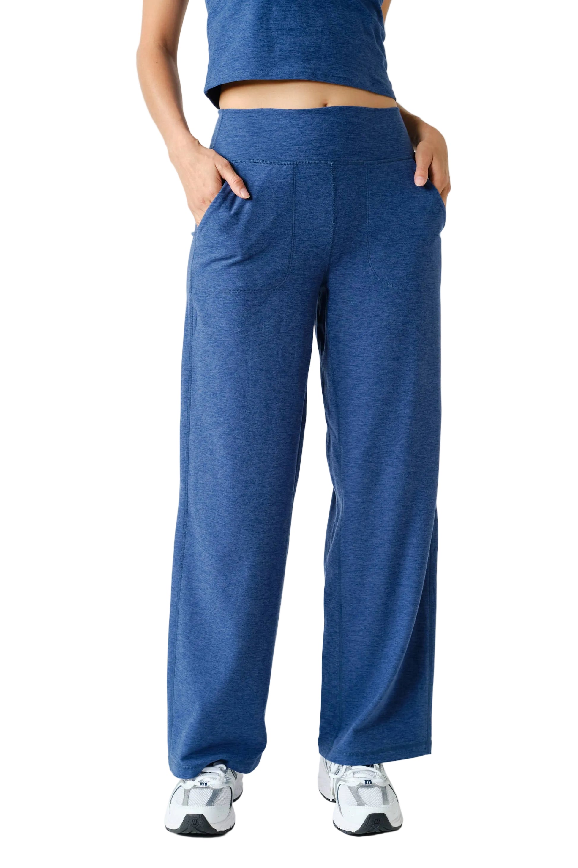 Person wearing blue sweatpants on a white background