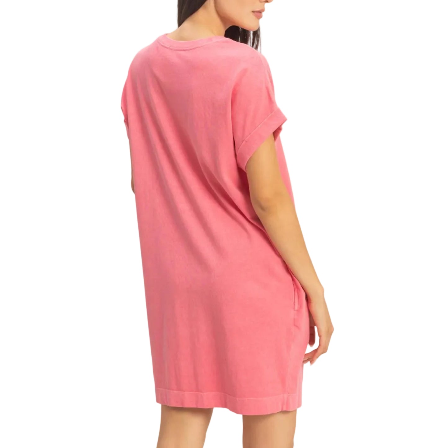 Woman wearing a pink t-shirt dress against a plain background